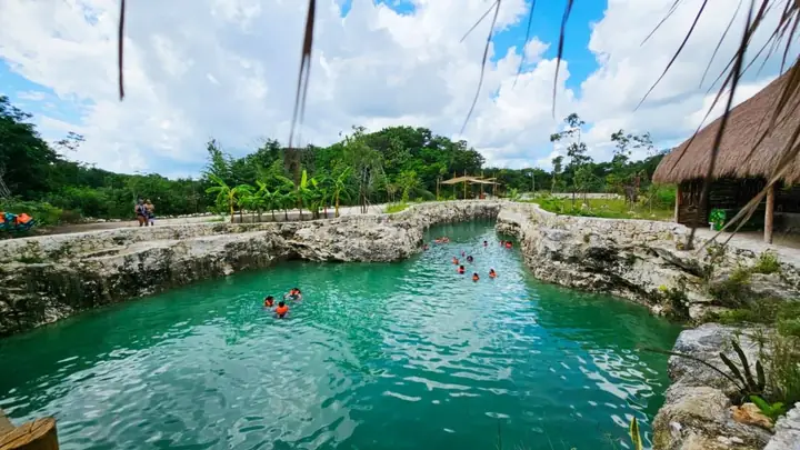 Hidden cenote with clear water and cave formations