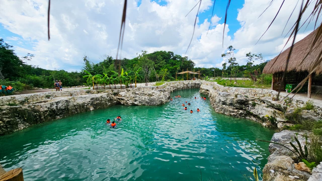 Hidden cenote with clear water and cave formations